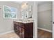 Modern bathroom with double granite vanity, dark cabinets, and mirrors at 7401 Hancock St, Riverview, FL 33578