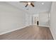 Large bedroom with hardwood flooring, ceiling fan, and open bathroom access at 7401 Hancock St, Riverview, FL 33578