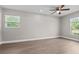 Bright bedroom featuring windows with natural light and hardwood flooring at 7401 Hancock St, Riverview, FL 33578