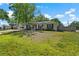 Well-maintained one-story home with a spacious front yard and inviting entrance at 7401 Hancock St, Riverview, FL 33578