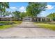 Single-story home with a long driveway and a green front yard at 7401 Hancock St, Riverview, FL 33578