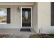 Close up of the front door with a decorative glass insert and hardware at 7401 Hancock St, Riverview, FL 33578