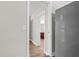 Hallway with wood floors and entrance to the kitchen at 7401 Hancock St, Riverview, FL 33578