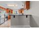 Updated kitchen features wood cabinets, stainless steel appliances, tile backsplash, and counter with seating at 7401 Hancock St, Riverview, FL 33578
