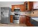 Spacious kitchen featuring stainless steel appliances, wood cabinets, and modern design at 7401 Hancock St, Riverview, FL 33578