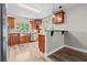 Updated kitchen features wood cabinets, stainless steel appliances, tile backsplash, and counter with seating at 7401 Hancock St, Riverview, FL 33578