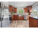 Updated kitchen with stainless steel appliances, wood cabinets, and a stylish tile backsplash at 7401 Hancock St, Riverview, FL 33578