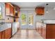 Bright kitchen featuring wood cabinets, stainless steel sink, and a door to the backyard at 7401 Hancock St, Riverview, FL 33578
