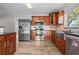 Modern kitchen features stainless appliances, wood cabinets, and ample counter space at 7401 Hancock St, Riverview, FL 33578