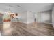 Open-concept living space showcasing hardwood floors and natural light from kitchen, creating a welcoming atmosphere at 7401 Hancock St, Riverview, FL 33578