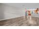 Open layout living room highlighting hardwood floors flowing into the kitchen area, enhancing spacious feel at 7401 Hancock St, Riverview, FL 33578