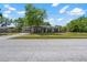 Spacious living area with hardwood floors, light gray walls and recessed lighting at 7401 Hancock St, Riverview, FL 33578