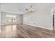 Bright living room featuring hardwood flooring and a classic chandelier at 7401 Hancock St, Riverview, FL 33578