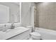 Well-lit bathroom features a sleek vanity, granite countertops, and a shower-tub combo with neutral tile at 8352 Greenway Ave, Wesley Chapel, FL 33544