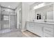 Bright bathroom features double vanity sinks, a tiled shower, and neutral colors at 8352 Greenway Ave, Wesley Chapel, FL 33544