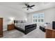 Primary bedroom with neutral paint, carpet, ceiling fan, large window, and a comfortable seating area at 8352 Greenway Ave, Wesley Chapel, FL 33544