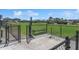 Community dog park featuring a fenced-in area, bench, and pet waste station at 8352 Greenway Ave, Wesley Chapel, FL 33544