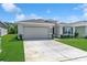 Attractive home with a two-car garage, manicured lawn, and clean, modern architectural details at 8352 Greenway Ave, Wesley Chapel, FL 33544