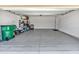 Spacious two-car garage with epoxy flooring, storage and a door to the interior of the house at 8352 Greenway Ave, Wesley Chapel, FL 33544