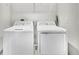 Laundry room with a neatly arranged side-by-side washer and dryer, and ample storage at 8352 Greenway Ave, Wesley Chapel, FL 33544