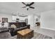 Open concept living room showing kitchen, tile floors, neutral paint, ceiling fan and breakfast nook at 8352 Greenway Ave, Wesley Chapel, FL 33544