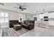 Spacious living room with tile flooring, leather sofas, and ample natural light at 8352 Greenway Ave, Wesley Chapel, FL 33544