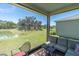 Relax on the screened patio with scenic views of the pond and lush backyard at 8352 Greenway Ave, Wesley Chapel, FL 33544