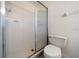 Bathroom features a glass enclosed shower, white tile, and modern toilet at 8445 Calais N, Pinellas Park, FL 33781