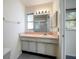 Bathroom with vanity, white cabinets, a mirror, and shower/tub combo at 8445 Calais N, Pinellas Park, FL 33781
