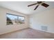 Bright bedroom with large window, neutral carpet, and a ceiling fan at 8445 Calais N, Pinellas Park, FL 33781