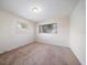 This bedroom features carpet flooring, neutral walls, and dual window views at 8445 Calais N, Pinellas Park, FL 33781