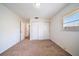 Bedroom with carpet, closet, and natural lighting at 8445 Calais N, Pinellas Park, FL 33781