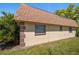 Exterior side view of the home showing architectural details and landscaping at 8445 Calais N, Pinellas Park, FL 33781