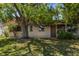 Quaint house exterior with lovely lawn and a large shade tree at 8445 Calais N, Pinellas Park, FL 33781