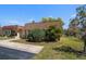 Landscaped home exterior with a well-manicured lawn and concrete driveway in a wonderful community at 8445 Calais N, Pinellas Park, FL 33781