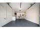 Spacious garage with painted floor, storage shelves and appliances at 8445 Calais N, Pinellas Park, FL 33781