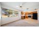Bright kitchen with wood cabinets, black appliances, tile floors, and a big window at 8445 Calais N, Pinellas Park, FL 33781