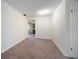 Carpeted living room with neutral walls leads to kitchen in this quaint property at 8445 Calais N, Pinellas Park, FL 33781
