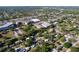 An aerial view of homes, trees, and commercial buildings on a sunny day in a city at 910 Lakeside Dr, Largo, FL 33778