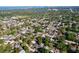 An aerial view of the neighborhood with lots of trees, lakes, and homes in the distance at 910 Lakeside Dr, Largo, FL 33778