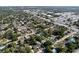 An aerial view shows many houses, trees, and some swimming pools on a sunny day at 910 Lakeside Dr, Largo, FL 33778