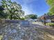An inviting backyard showcases a round pool, a tiki hut, and a tranquil, fenced outdoor space at 910 Lakeside Dr, Largo, FL 33778