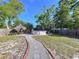 This yard has a refreshing pool, complemented by a charming tiki hut and stone path for relaxing at 910 Lakeside Dr, Largo, FL 33778