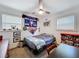 Comfortable bedroom featuring a ceiling fan, baseball decor, and natural light from two windows at 910 Lakeside Dr, Largo, FL 33778
