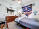 A bedroom with posters, baseball memorabilia, and a comfortable space with natural light from a window at 910 Lakeside Dr, Largo, FL 33778