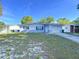 Charming single story home with light colored paint and a one car garage on a sunny day at 910 Lakeside Dr, Largo, FL 33778
