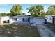 A bright single-story home showcases a clean exterior and attached garage, set against a clear sky at 910 Lakeside Dr, Largo, FL 33778