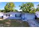 Charming single-story home boasts a clean and modern exterior with an attached garage and well-kept yard at 910 Lakeside Dr, Largo, FL 33778
