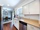 Bright kitchen featuring stainless appliances, wood flooring and a view into the dining area at 910 Lakeside Dr, Largo, FL 33778