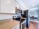Open concept kitchen featuring stainless microwave and oven appliances that leads to a dining area at 910 Lakeside Dr, Largo, FL 33778